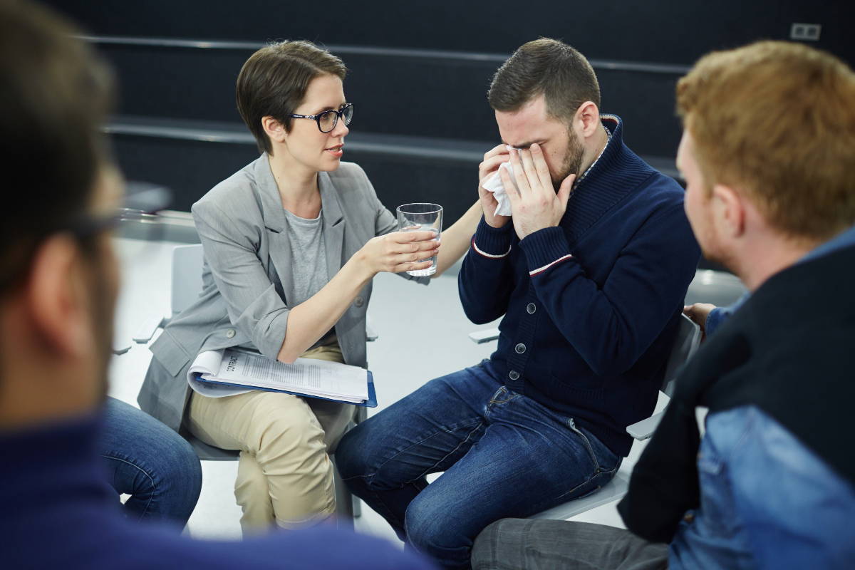 A woman participating in group therapy training to become an addiction counselor.