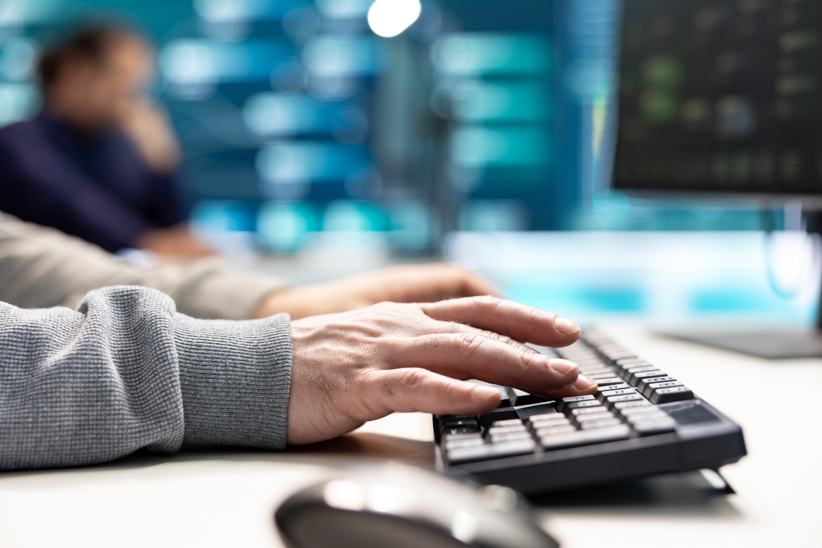 Hands typing on a keyboard.